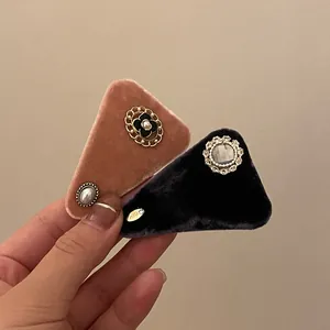 Detailed close-up of premium velvet hair clips with elegant zircon and pearl embellishments