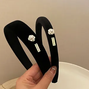 Elegant black velvet headband with white camellia flower and pearl detail for women