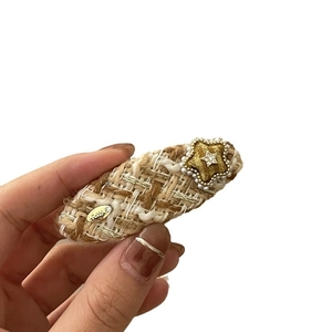 Elegant tweed fabric hair clip with a golden pearl star and sparkling zircon detail