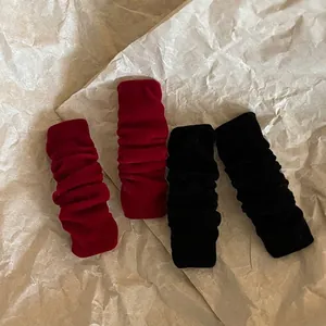 Set of 4 vintage burgundy and black velvet hair scrunchies on rustic paper background