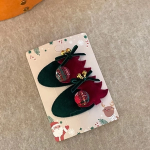Détail de barrettes à cheveux chaussettes de Noël en velours avec nœuds et clochettes dorées
