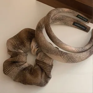 Close-up of handmade coffee plaid fabric headband and matching scrunchie set