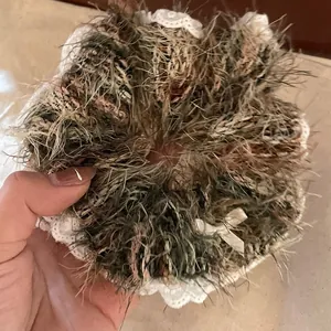 Close-up of knit lace scrunchie featuring plush texture and white silk bow detail