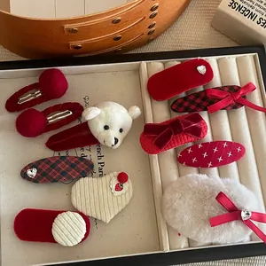 Detailed view of 10-piece festive red velvet and pearl hair clips set for women and kids