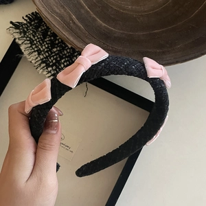 Close-up of black tweed headband featuring four pink velvet bows for a sweet elegant style
