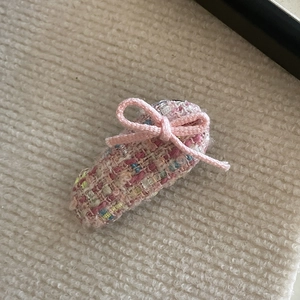 Detail of pink tweed bow hair clip with ballet slipper design and premium metallic clasp