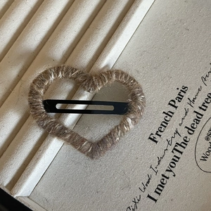 Minimalist brown twine wrapped heart hair clip on vintage jewelry display tray