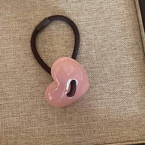 Cute pink heart resin hair tie with glossy jelly finish on a flexible brown elastic band