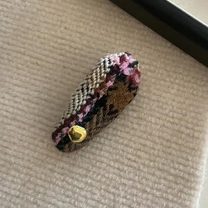 Detail of tweed waterdrop BB hair clip with colorful woven fabric and gold metal stud
