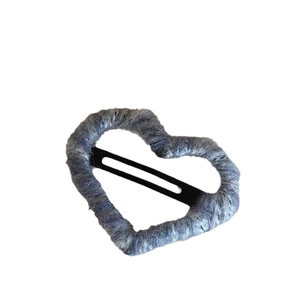 Minimalist grey-blue knitted heart hair clip with cozy wool texture on white background