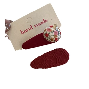 Red festive hair clips set with floral fabric bow and pearl detail on handmade card