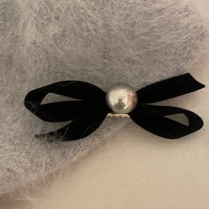 Elegant black velvet bow hair clip with a center pearl detail and gold metal grip