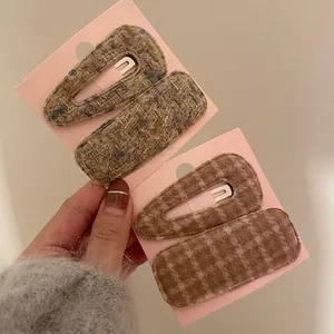 Plaid and woolen fabric BB hair clip set for women featuring brown and beige patterns