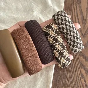 Detailed set of five autumn houndstooth and leather BB hair clips in warm brown tones