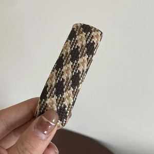 Brown houndstooth plaid hair clip for women held in hand for side bangs or back hair