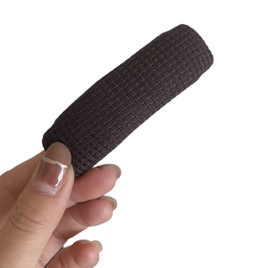 Brown houndstooth knitted hair clip for women with detailed woven texture on white background