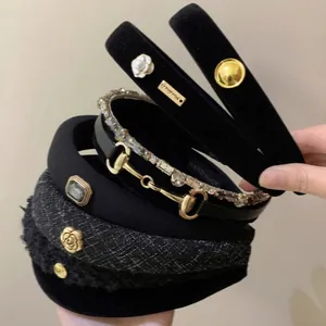 Elegant black velvet and tweed headband set with camellia and metal buckle details