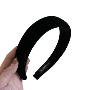 Elegant black velvet padded headband with handmade label for a vintage hair styling look