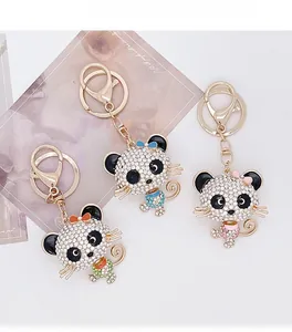 Detailed view of three sparkly rhinestone cat keychains with enamel bows and gold lobster clasps