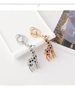 Detailed view of gold and silver giraffe keychains with sparkling crystals and lobster clasp