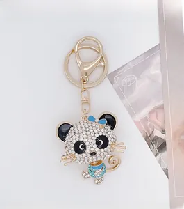 Detail of a sparkling rhinestone-studded panda keychain with a gold-tone metal clasp