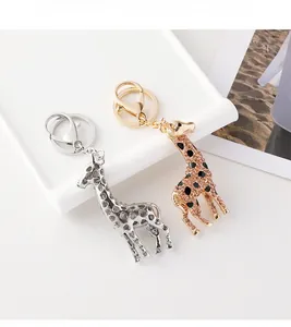 Detail of giraffe keychain charms with crystal diamonds and black enamel in gold and silver