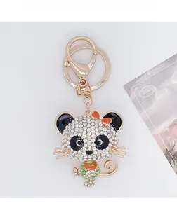 Close-up of diamond-encrusted cartoon panda keychain with gold plating and lobster clasp