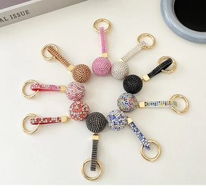 Macro shot of assorted colorful sparkling crystal ball keychains with gold-plated rings