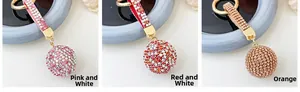 Detailed comparison of sparkling rhinestone ball keychains in pink, red, and orange colors