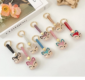 Collection of pearl fox keychains featuring colorful rhinestones in a luxury gift layout