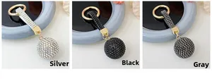 Detailed comparison of sparkling rhinestone ball keychains in silver, black and grey tones