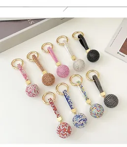 Detail showing various colors of rhinestone ball keychains with golden carbine clips