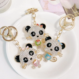 Three creative panda keychains with shiny crystals in pink, green and blue themes