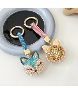 Detail of fox-shaped keychain with sparkling rhinestones and elegant pearls charms