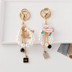 Exquisite pearl cat keychains with golden lobster clasps and perfume bottle charms