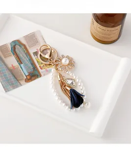 Detailed shot of sunflower pearl keychain with blue fabric petals on a white tray