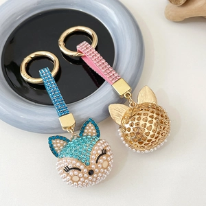 Elegant fox head keychain with pearls and crystals in blue and pink metallic designs