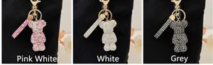 Detailed comparison of three sparkling rhinestone bear keychains in pink, white and grey