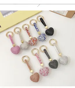 Macro shot of colorful heart-shaped rhinestone keychains with golden metal ring hooks