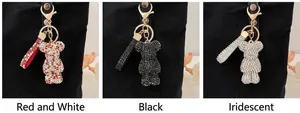 Detailed views of rhinestone-encrusted bear keychains in red, black, and iridescent colors