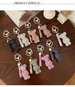 Macro detail of various rhinestone-encrusted bear keychains with gold lobster clasps