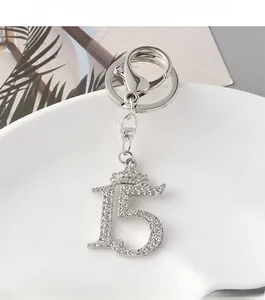 Detail of silver number 15 keychain with rhinestone crown and sparkling crystals