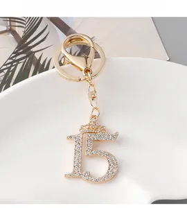 Macro detail of golden number 15 keychain with crystal rhinestones and crown charm