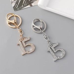 Elegant number 15 keychain with rhinestone crown decoration in gold and silver finish
