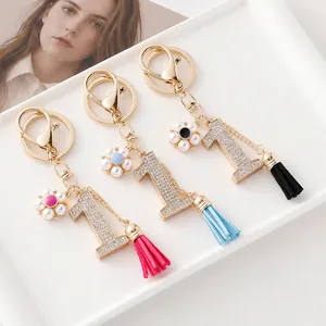 Porte-clés Numéro Un de Luxe avec Strass Fleur de Künstliche Perle et Gland en Similicuir Breloque de Sac en Alliage Doré pour Femme