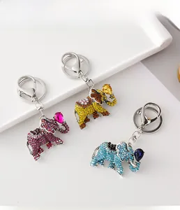 Detailed display of rhinestone elephant keychains in purple, yellow, and blue colors