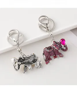 Detail of silver elephant brooch keychain with purple rhinestones and pink heart gem