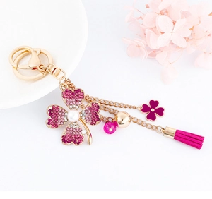 Detail of flower keychain with crystal clover pendant, pink leather tassel and beads