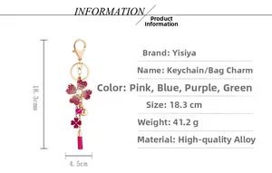 Detail view of pink rhinestone flower keychain with metallic tassel and faux pearls