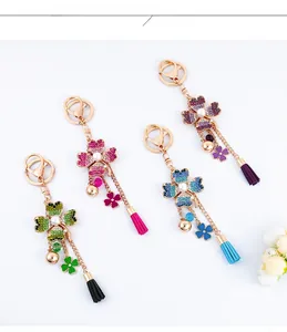 Detail of four-leaf clover keychains with crystals, pearls and velvet tassels